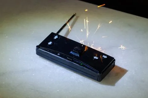Damaged remote control device with fire and smoke as overheating and fire r.. Stock Photos