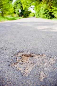 Damaged road early spring Stock Photos