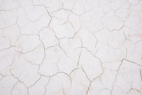 Damaged sandy white surface texture with cracks Stock Photos