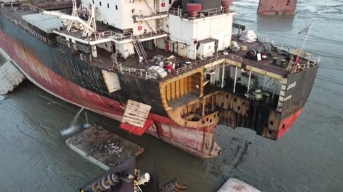 Damaged ship with workers standing on deck at a ship breaking yard in Bangladesh Video stock 327165273
