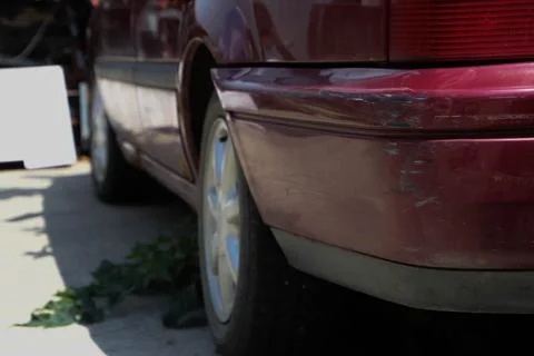 Damaged side back of an old car. Stock Photos
