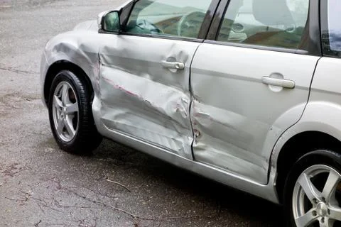 Damaged silver car, scratches on the doors Stock Photos