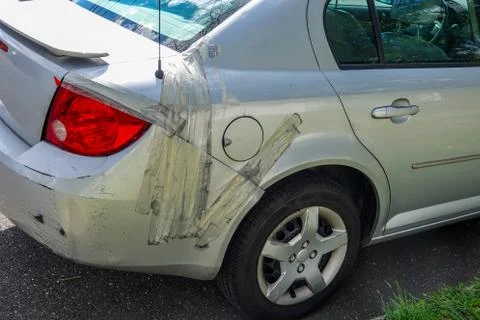 Damaged small gray car Stock Photos
