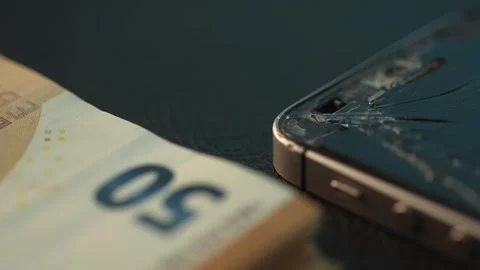 Damaged Smartphone and Cash on Table. Stock Footage 261906949