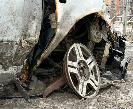 Damaged smashed grey sedan car on the street as a result of a traffic accid.. Stock Photos