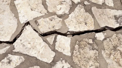 A damaged stone patio floor shows large crack and is in need of repair Stock Footage 344906921