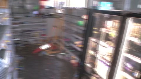 Damaged Store Interior With Overturned Shelving And Scattered Debris After A Stock Footage 336177883