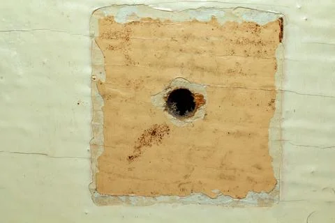 Damaged surface with a hole in old paper texture background for design Stock Photos