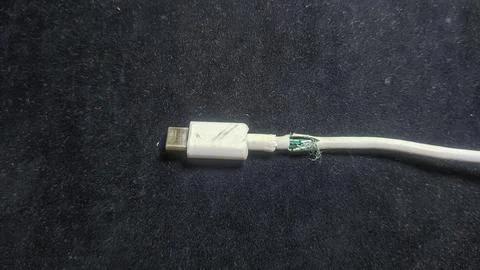 Damaged Type-C charging cable with damaged insulation Stock Photos