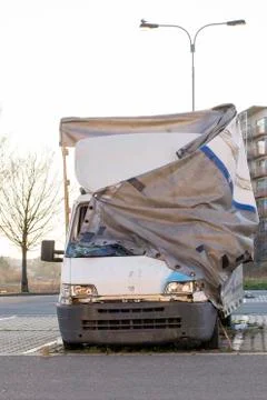 Damaged van left behind by a driver. Broken truck abondoned by a driver and d Stock Photos