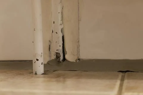 Damaged Wall Corner with Peeling Paint and Pipe Stock Photos