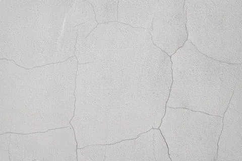Damaged wall with cracks, uneven texture, rough concrete background Stock Photos