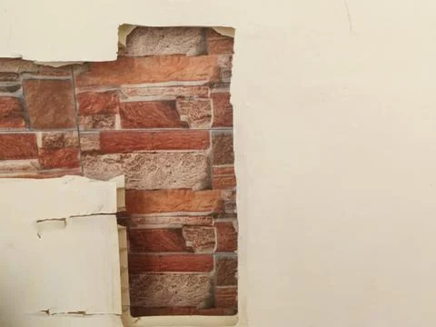 Damaged Wall Plastic Layer Revealing Brick Pattern 스톡 사진