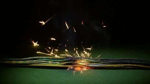 Damaged wires inside the harness begin to smolder, creating sparks and a local g Stock Footage 323017705