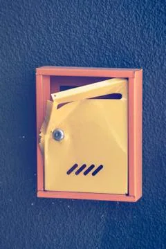 Damaged yellow mailbox Stock Photos