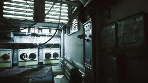Damp industrial corridor. Dark utility space with hanging cables and cameras Stock Footage 341821533