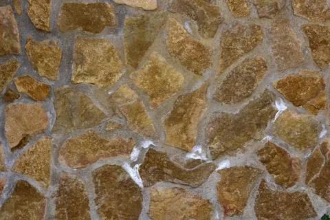 Damp natural stone wall with efflorescent saltpetre Salt Stock Photos
