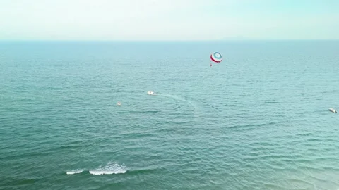 Danang beach scene capturing water sports and holiday fun. With a vibrant Stock Footage 338204065