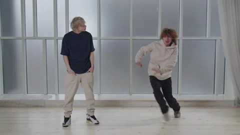 Dance battle concept. Breakdance performers showing their moves. Two guys Stock Footage 231675765