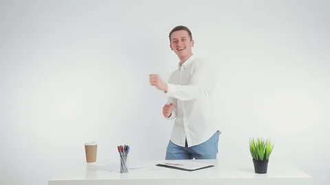 Dance of a businessman at work in the workplace. A young employee dances near Stock Footage 125463667