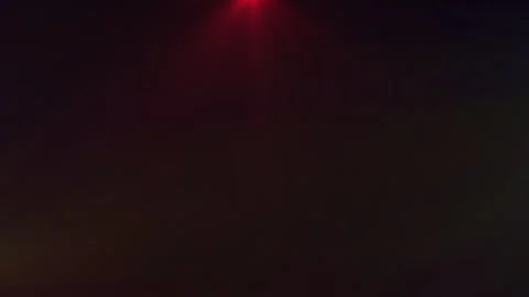 A dance of colored lights swirls in the background. 스톡 동영상 309427927