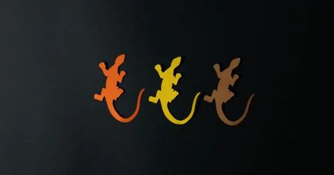 Dance of colored lizards on a white background. Stock Photos