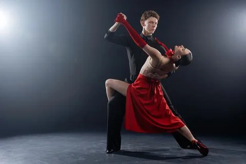 Dance Couple Performing Dramatic Partner Pose in Studio with Controlled Lig.. Stock Photos