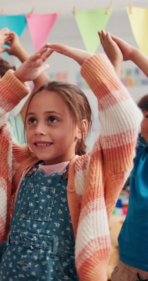 Dance, development and learning with kids in classroom at school together for Stock Footage 307998447