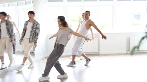 Dance group in casual clothes training to dance hip-hop and breakdance together Stock Footage 341426430