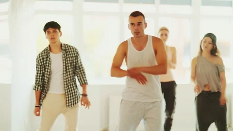 Dance group in casual clothes training to dance hip-hop and breakdance together Stock Footage 344844320