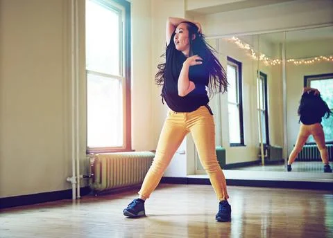 Dance - Heart first, feet second. a young woman dancing in a studio. Stock Photos