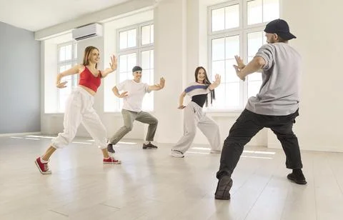 Dance Instructor Leading Four Dancers Through Energetic Studio Choreography Stock Photos