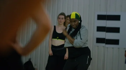 Dance instructor showing her class how to do a dance step Stock Footage 118936725
