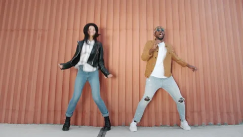 Dance loop of creative youth Afro-American man and Caucasian woman jumping Stock Footage 161405183