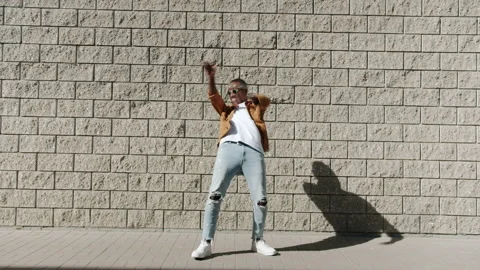 Dance loop of excited African American guy moving partying outdoors on sunny day Stock Footage 161396539
