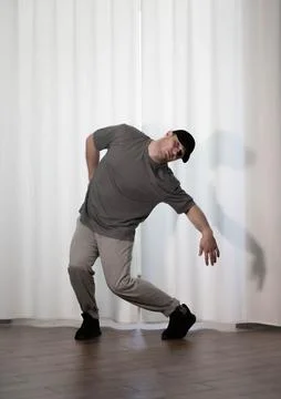 Dance in motion, pose of a man in hip-hop style clothes. Sports dancing guy.. Foto stock