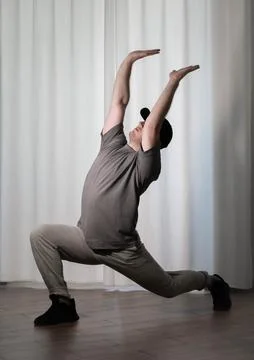 Dance in motion, pose of a man in hip-hop style clothes. Sports dancing guy.. Stock Photos