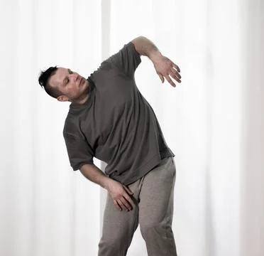 Dance in motion, pose of a man in hip-hop style clothes. Sports dancing guy.. Stock Photos