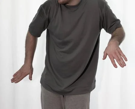 Dance in motion, pose of a man in hip-hop style clothes. Sports dancing guy.. Stock Photos