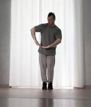 Dance in motion, pose of a man in hip-hop style clothes. Sports dancing guy.. Stock Photos