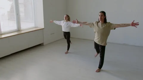 Dance Partners Performing Forward Leg Swings during Warmup Stock Footage 282525923