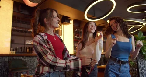 Dance Party Delight: Three Joyful Girls Dancing at a Sunny Cafe-Bar Bachelorette Видео 242899329