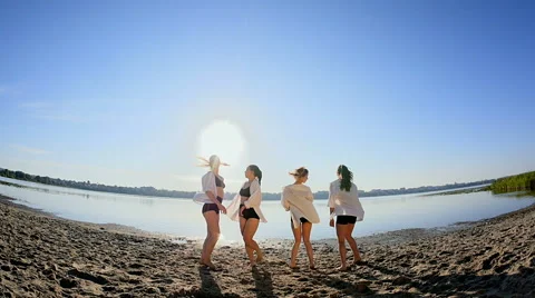 Dance performance of four girls on sand beach near lake at dawn Stock Footage 65321574