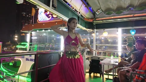 A dance performer entertains guests aboard a cruise boat on the Han River. 스톡 동영상 330760103