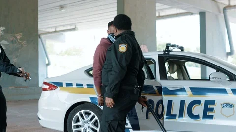 Dance time two policemen are standing near the car with a african american Video stock 112997742