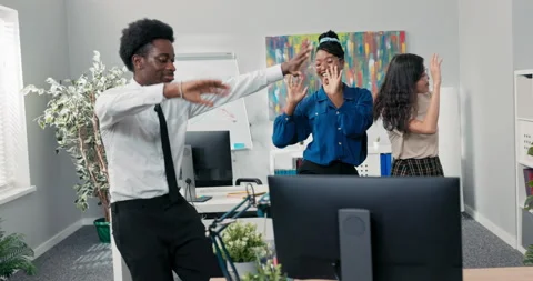 Dance at work, office, break from duties, company party, two girls and a man in 库存影片 169553336