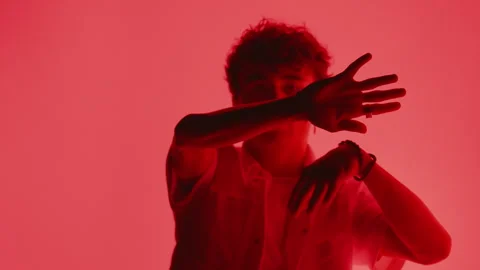 Dancer Against Vivid Red Background Stock Footage 255537948