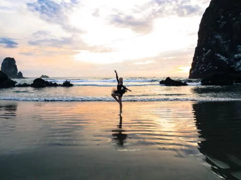 Dancer on the beach at sunset Stock Photos