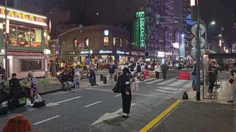 Dancer in Black Hat Performing at Night Intersection, Argentina 8K Stock Footage 306463798