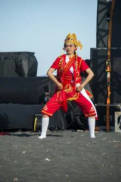 A dancer in a bright red costume performs on the stage Stock Photos